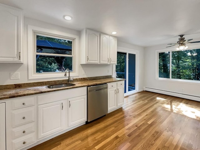 kitchen with baseboard heating, stainless steel dishwasher, light wood-style floors, white cabinetry, and a sink