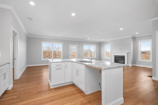 33 Crestwood Cir Unit 45, Northbridge, MA 01588 - kitchen with open floor plan, ornamental molding, recessed lighting, light wood-style flooring, and light stone countertops