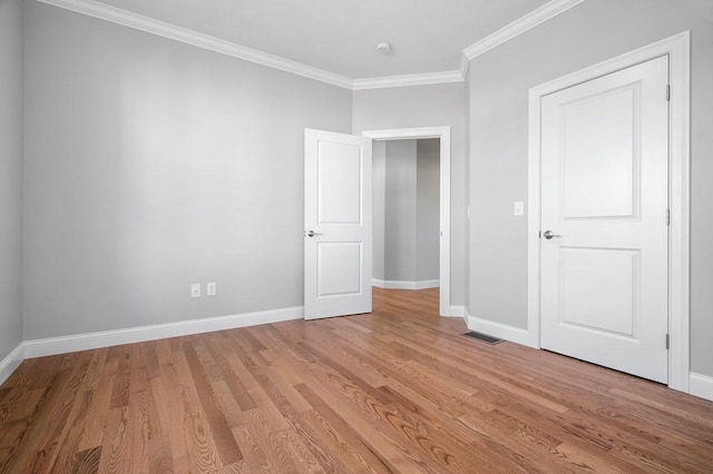 33 Crestwood Cir Unit 45, Northbridge, MA 01588 - unfurnished bedroom featuring crown molding and light wood-style flooring