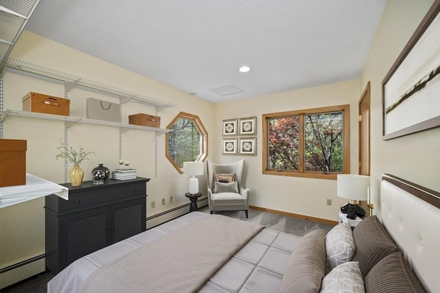 bedroom with multiple windows and a baseboard heating unit