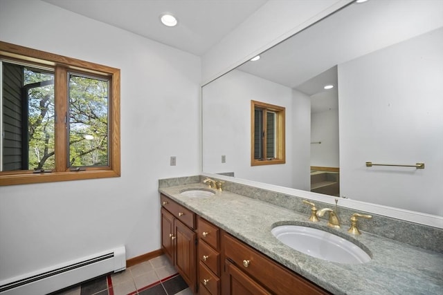 bathroom featuring tile patterned flooring, vanity, and a baseboard heating unit