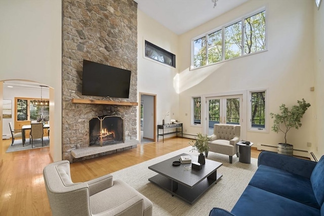 living room with plenty of natural light, hardwood / wood-style floors, and a high ceiling