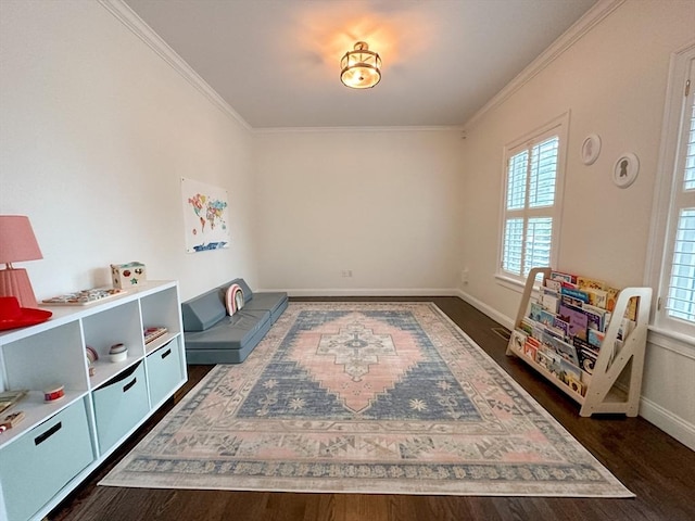 rec room with ornamental molding, dark wood-style floors, and baseboards