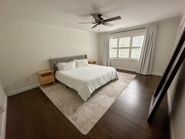 bedroom featuring a ceiling fan, wood finished floors, and baseboards