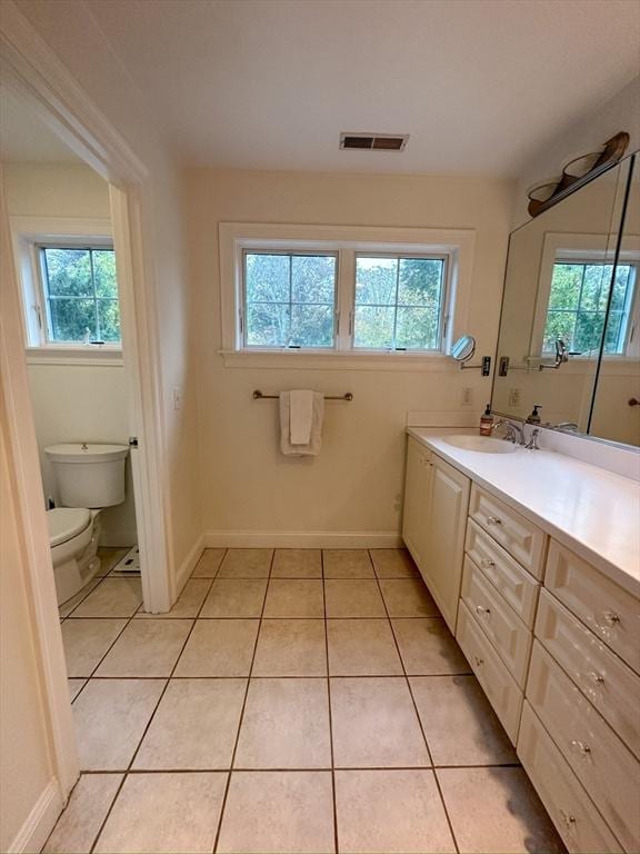bathroom featuring visible vents, a wealth of natural light, and tile patterned flooring