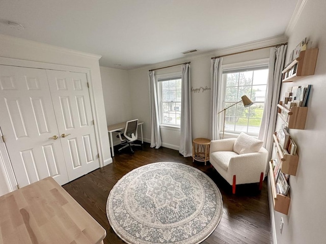 living area featuring crown molding, visible vents, baseboards, and dark wood finished floors