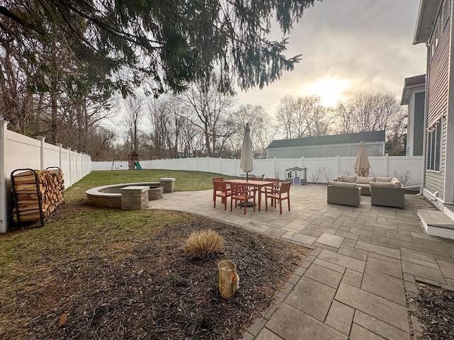 exterior space featuring an outdoor living space with a fire pit, a patio, and a fenced backyard