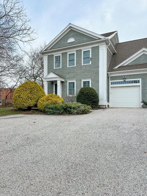 view of front facade with a garage and aphalt driveway