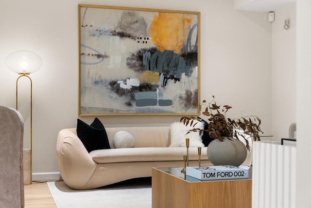 sitting room featuring baseboards and wood finished floors