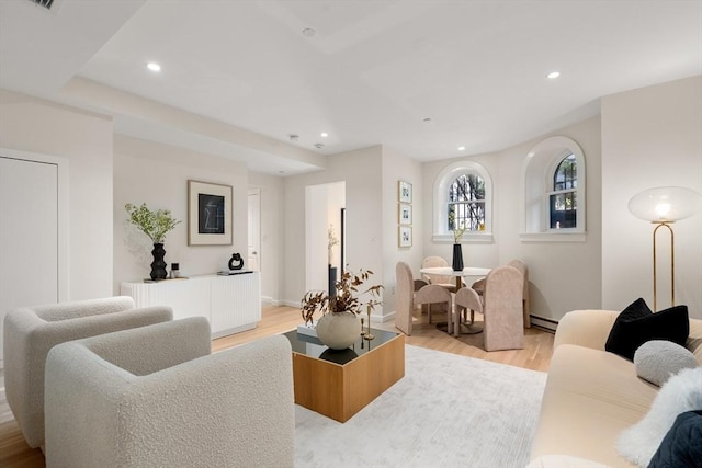 living room featuring recessed lighting, baseboards, light wood finished floors, and a baseboard radiator