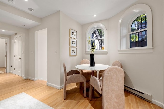 dining area featuring recessed lighting, a baseboard radiator, wood finished floors, and baseboards