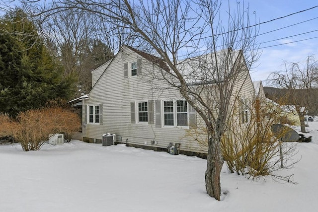 view of snowy exterior with central air condition unit