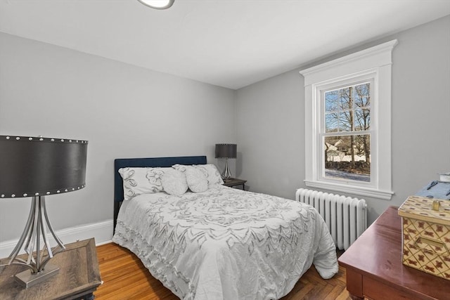 bedroom featuring wood-type flooring and radiator