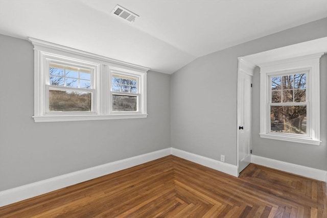 bonus room with lofted ceiling and dark parquet floors