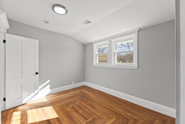 interior space featuring lofted ceiling and parquet floors