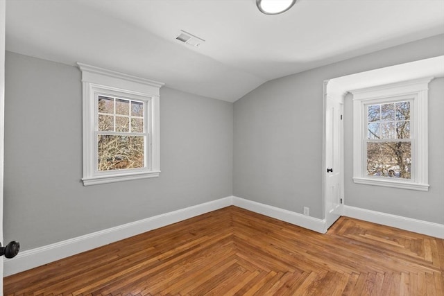 additional living space featuring lofted ceiling and parquet flooring