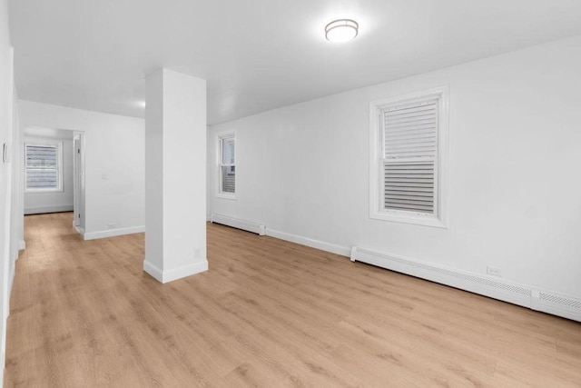 interior space featuring a baseboard radiator and light hardwood / wood-style floors