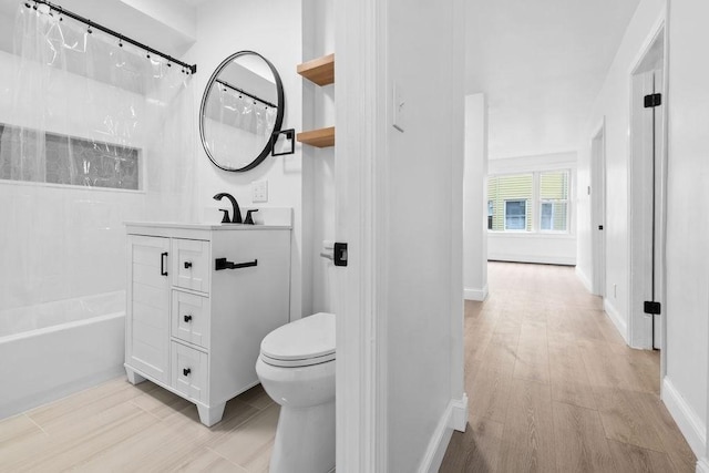 full bathroom with vanity, hardwood / wood-style floors, shower / bathtub combination with curtain, and toilet