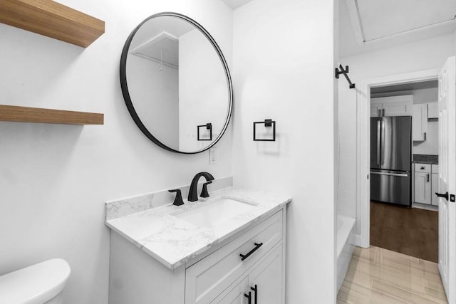 bathroom featuring tile patterned flooring, vanity, and toilet