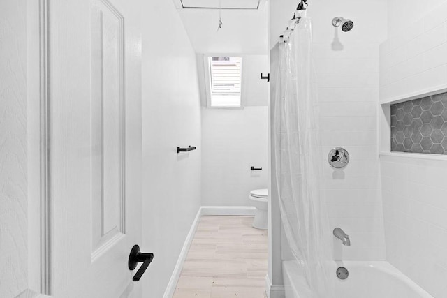 bathroom featuring hardwood / wood-style flooring, toilet, and shower / tub combo with curtain