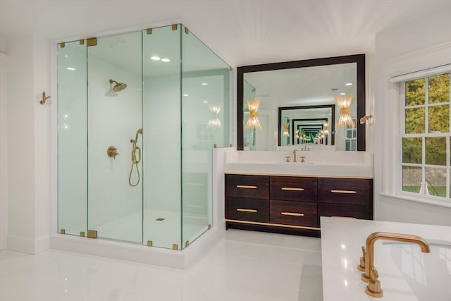 bathroom featuring a healthy amount of sunlight, a stall shower, and vanity