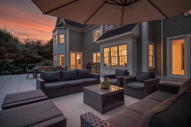 patio terrace at dusk featuring an outdoor living space