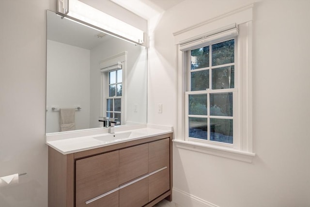 bathroom with baseboards and vanity