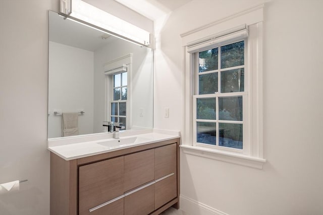 bathroom with vanity and baseboards