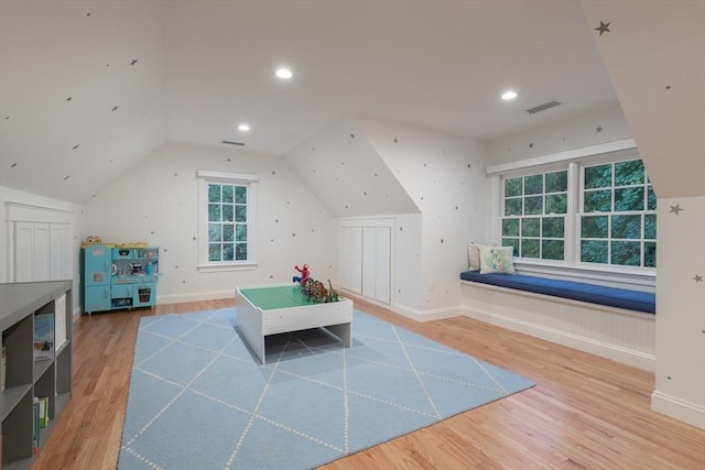 rec room featuring visible vents, vaulted ceiling, baseboards, and wood finished floors