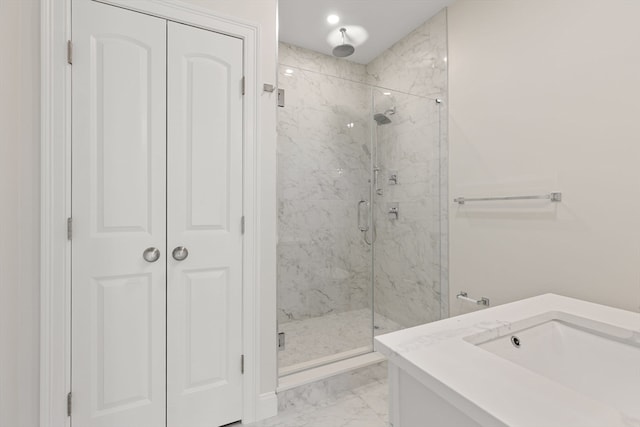 full bathroom featuring vanity, marble finish floor, and a marble finish shower