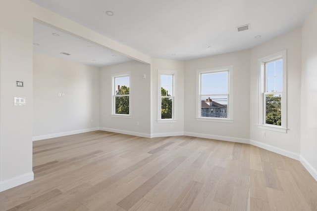 empty room featuring recessed lighting, visible vents, light wood-style flooring, and baseboards