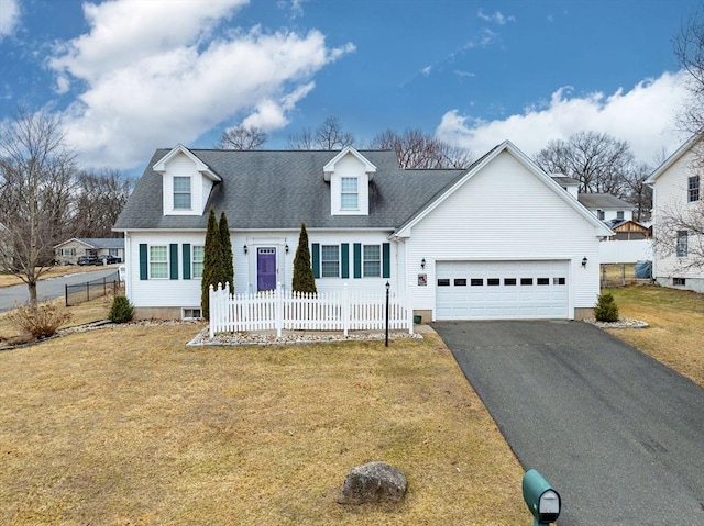 cape cod house featuring a front lawn, aphalt driveway, fence, roof with shingles, and a garage