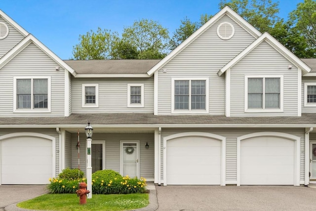 140 Commonwealth Ave Unit 12, North Attleboro, MA 02763 - multi unit property featuring an attached garage, driveway, a shingled roof, and covered porch
