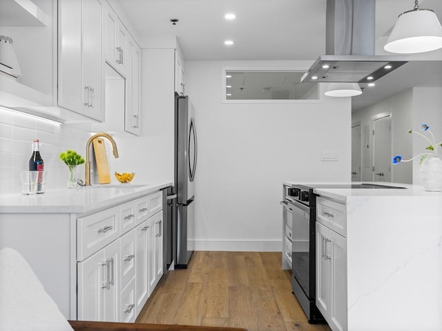 kitchen with a sink, island exhaust hood, light wood-type flooring, recessed lighting, and black / electric stove
