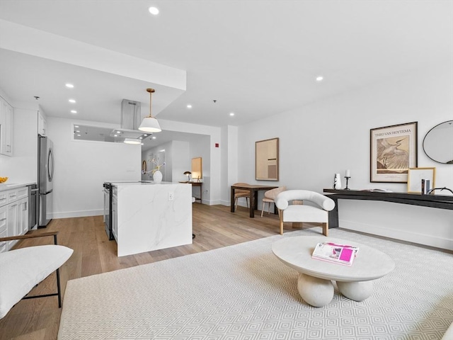 interior space featuring light wood-style floors, baseboards, and recessed lighting