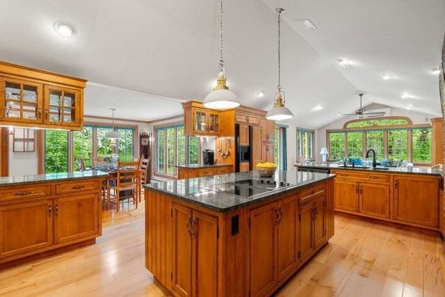 75 Haynes Rd, Sudbury, MA 01776 - kitchen featuring lofted ceiling, fridge with ice dispenser, brown cabinets, black electric stovetop, and a center island