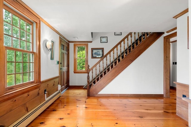75 Haynes Rd, Sudbury, MA 01776 - entrance foyer featuring a baseboard heating unit, stairs, light wood finished floors, and plenty of natural light