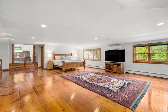 75 Haynes Rd, Sudbury, MA 01776 - bedroom with baseboard heating, a baseboard heating unit, wood-type flooring, recessed lighting, and a wall mounted air conditioner