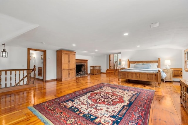 75 Haynes Rd, Sudbury, MA 01776 - bedroom with light wood-type flooring, recessed lighting, and a fireplace