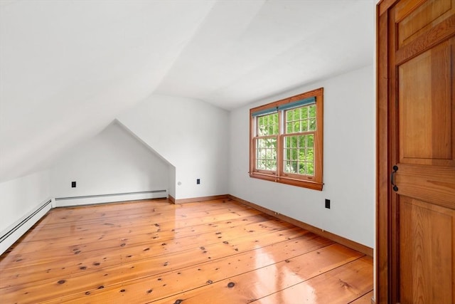 75 Haynes Rd, Sudbury, MA 01776 - additional living space with lofted ceiling, light wood finished floors, a baseboard heating unit, and baseboards