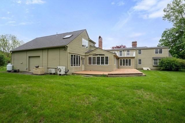 75 Haynes Rd, Sudbury, MA 01776 - rear view of house with ac unit, a deck, a yard, and a chimney