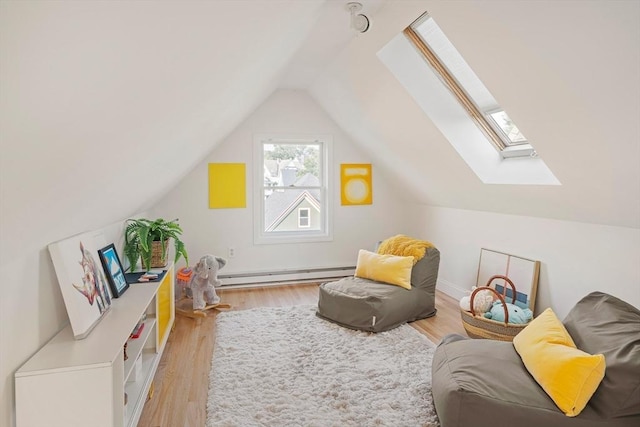 22 Robinson Unit 3, Somerville, MA 02145 - living area featuring a baseboard heating unit, a skylight, vaulted ceiling, and wood finished floors