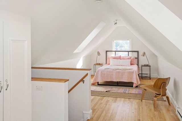 22 Robinson Unit 3, Somerville, MA 02145 - bedroom featuring a skylight, vaulted ceiling, light wood-type flooring, and baseboard heating