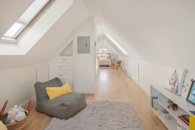 22 Robinson Unit 3, Somerville, MA 02145 - additional living space with a skylight, electric panel, baseboard heating, vaulted ceiling, and light wood-style floors