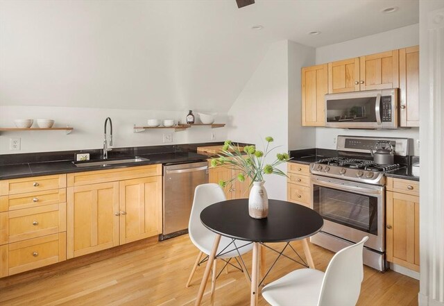 22 Robinson Unit 3, Somerville, MA 02145 - kitchen with stainless steel appliances, light brown cabinetry, dark countertops, light wood-style flooring, and open shelves