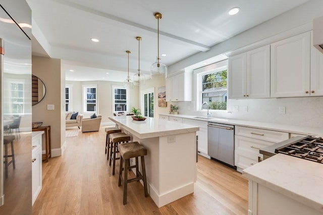 kitchen featuring stainless steel dishwasher, recessed lighting, light wood-style flooring, and white cabinetry