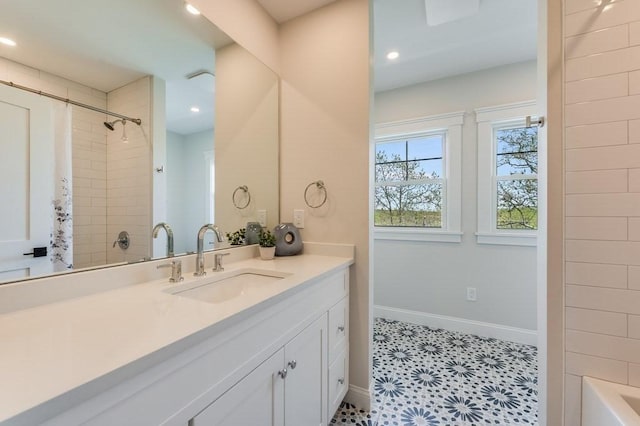 bathroom with baseboards, recessed lighting, shower / tub combo, and vanity