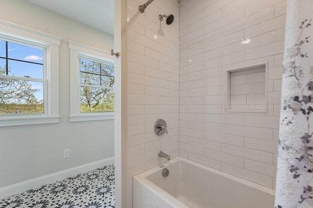 bathroom with baseboards and shower / bathtub combination with curtain