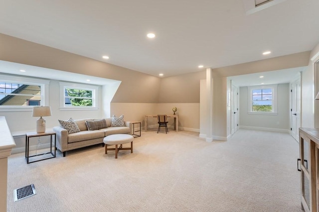 living room featuring recessed lighting, light colored carpet, a healthy amount of sunlight, and visible vents