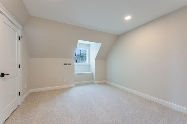 bonus room with light colored carpet, recessed lighting, baseboards, lofted ceiling, and visible vents